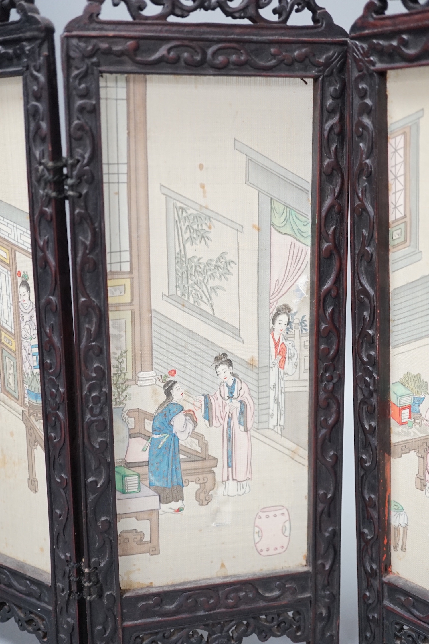 A Chinese hardwood framed painted silk four fold miniature screen, inset with painted silk panels, 28cm